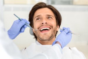portrait of handsome smiling man attending dentist BBR8FWX 1