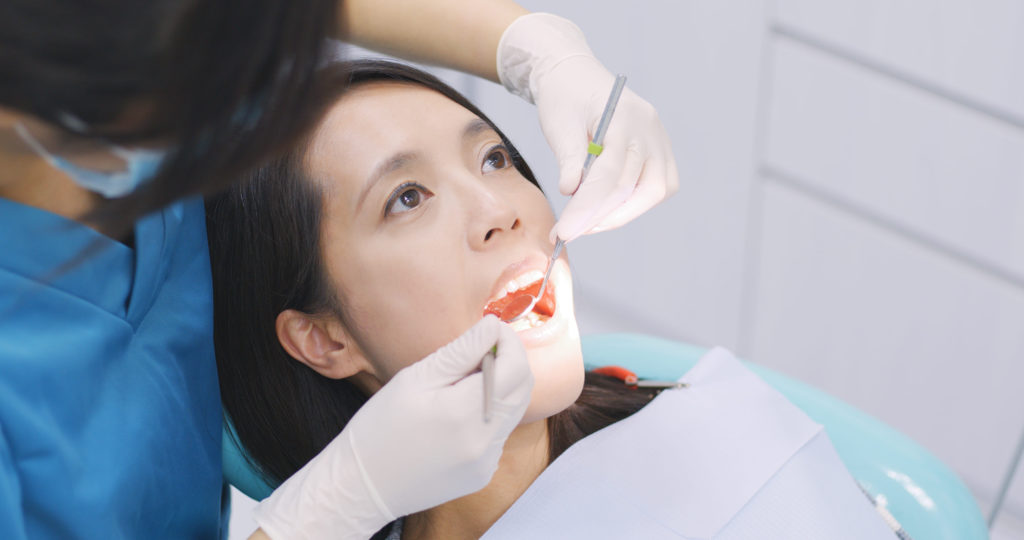 dentist examining a patient teeth in the dentist 2021 08 30 19 48 28 utc 1
