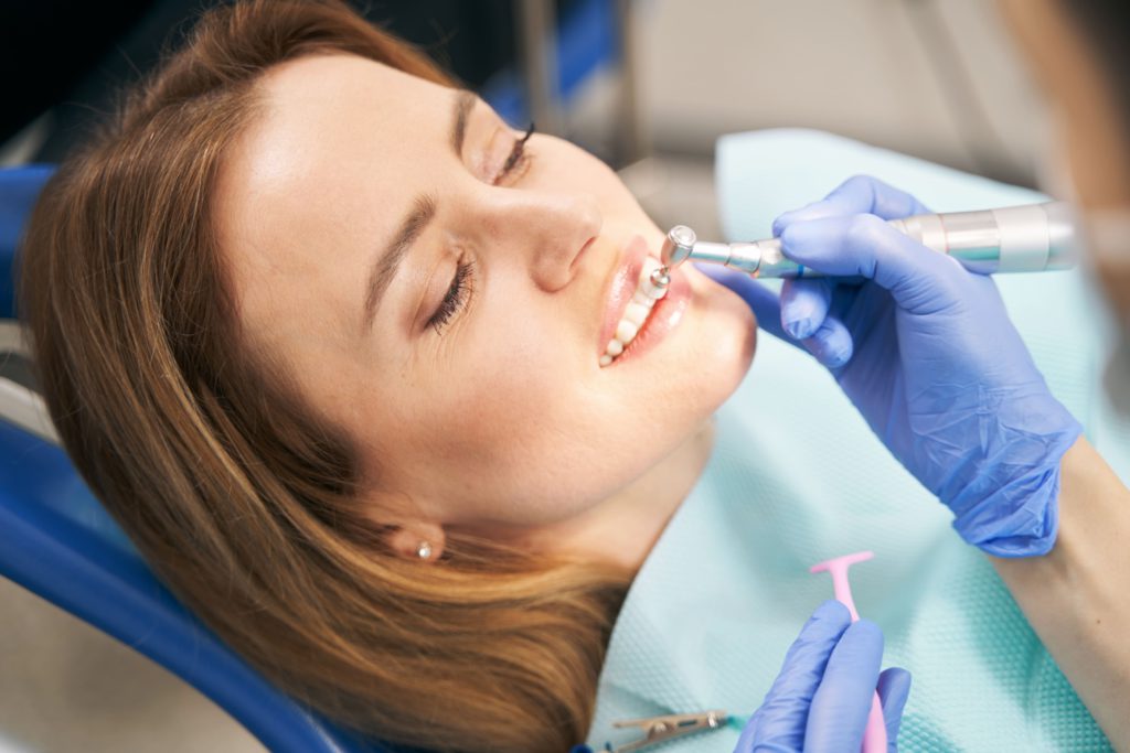 dentist performing teeth treatment with tooth poli 2022 03 31 17 41 54 utc 1