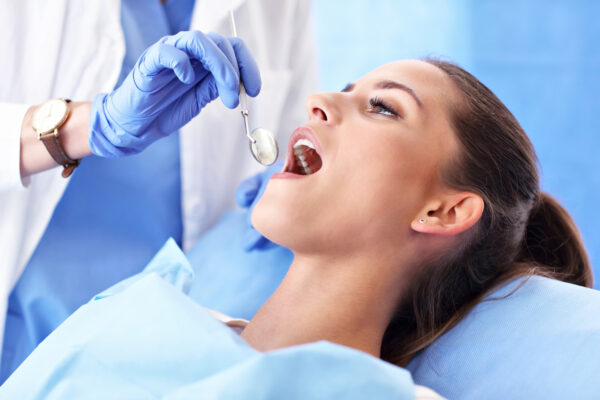 Picture of adult woman having a visit at the dentist's