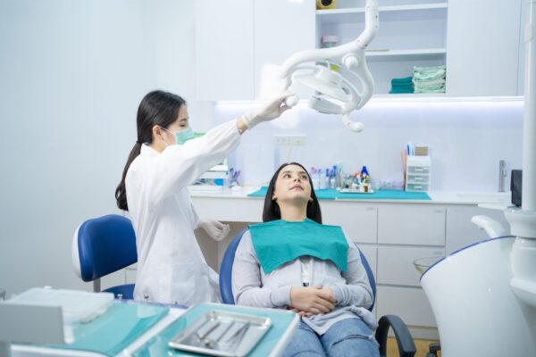 asian-female-dentist-adjust-dental-surgical-light-2021-12-09-07-32-46-utc (1)