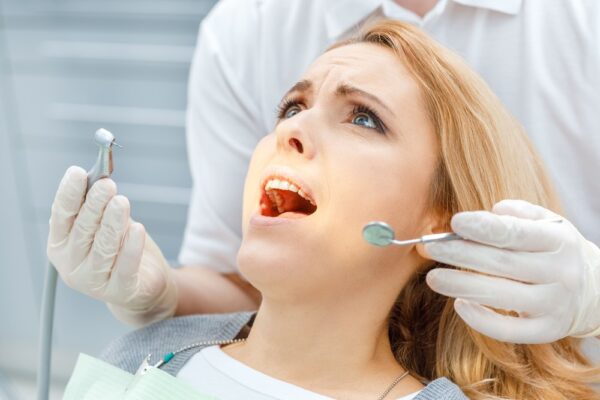 close-up-partial-view-of-dentist-curing-scared-pat-2022-01-18-23-41-42-utc (1)