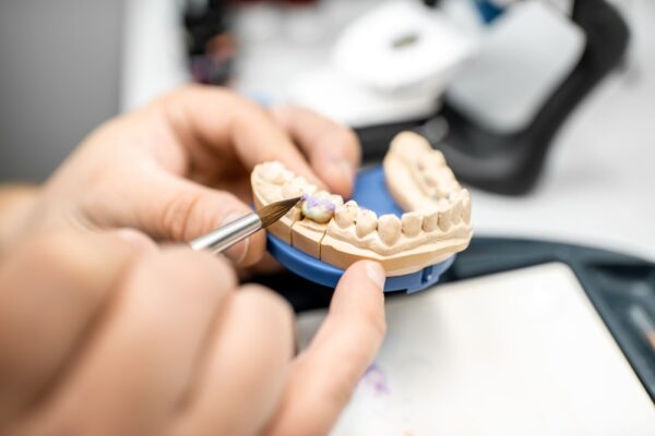 dental-technician-coloring-dental-prosthesis-G5VQCY5