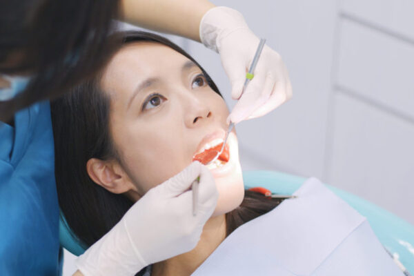 dentist-examining-a-patient-teeth-in-the-dentist-2021-08-30-19-48-28-utc (1)