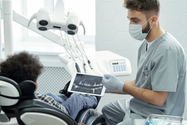 dentist-in-mask-gloves-and-uniform-interacting-wi-2022-01-20-15-55-03-utc (1)