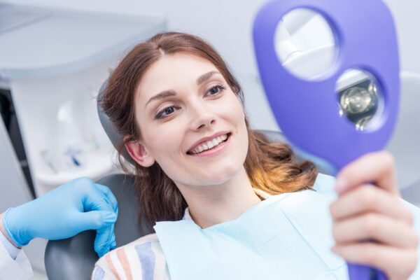 portrait-of-beautiful-woman-checking-teeth-after-c-2022-11-02-01-05-01-utc (2) (1)