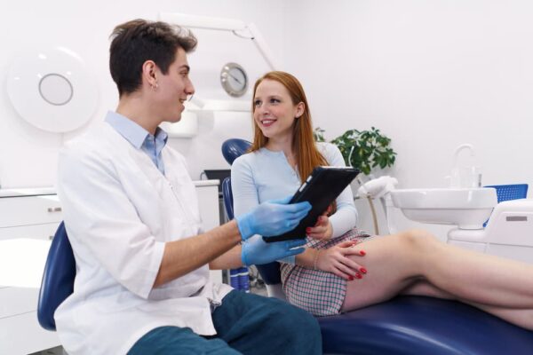 positive-dentist-and-patient-with-tablet-looking-a-2022-01-20-19-45-36-utc (1)