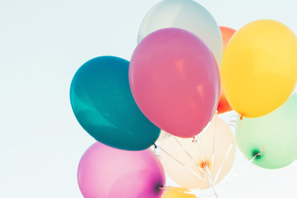 smiling-cute-girl-holding-colorful-balloons-in-the-2021-08-26-15-54-34-utc