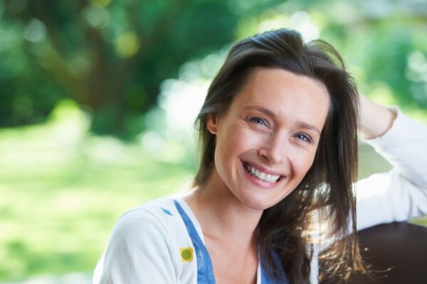 smiling-woman-sitting-outdoors-2022-03-04-01-52-53-utc (1)