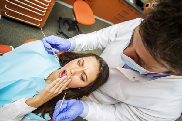 Young woman getting dental treatment in dentist office